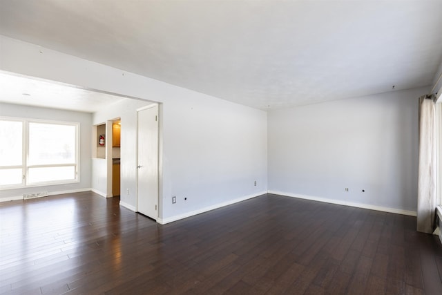 spare room featuring dark hardwood / wood-style floors