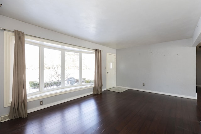 spare room with dark wood-type flooring