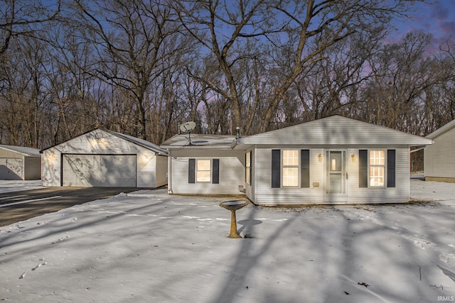 single story home featuring a garage and an outdoor structure