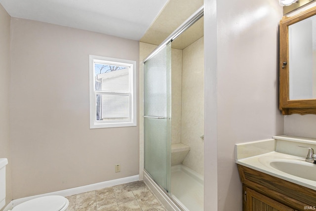 bathroom with vanity, toilet, and walk in shower