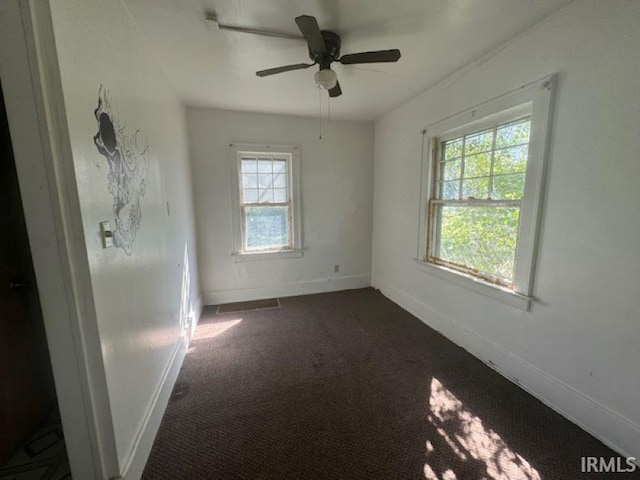 carpeted empty room featuring ceiling fan