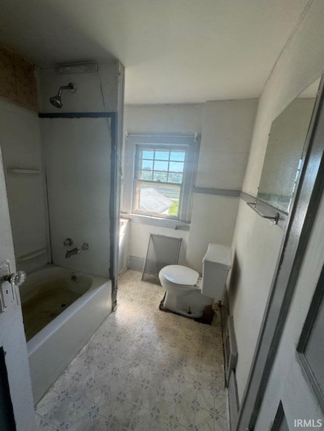 bathroom with bathtub / shower combination and toilet