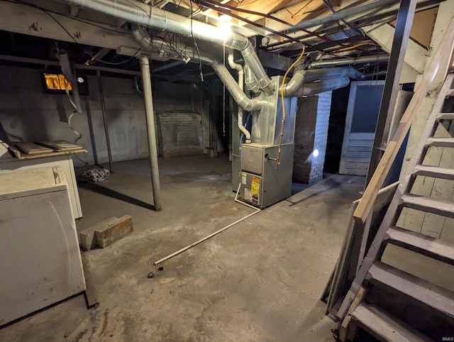 basement featuring heating unit and washer / dryer