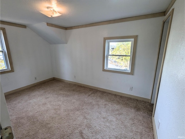 bonus room featuring lofted ceiling and light carpet