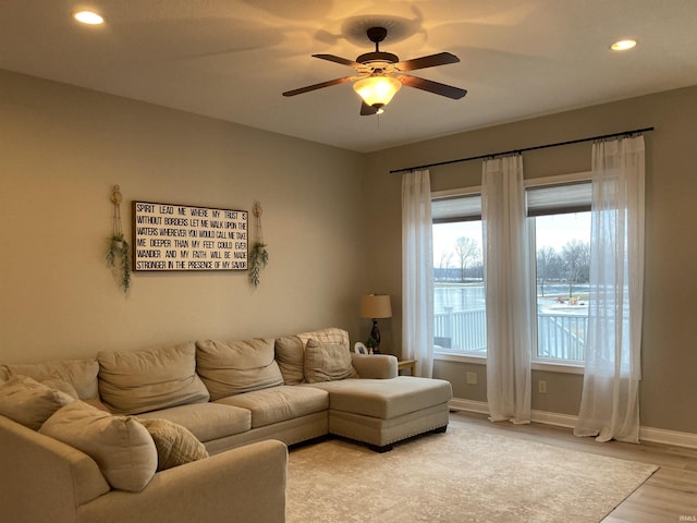 living area featuring recessed lighting, baseboards, light wood-style floors, and ceiling fan