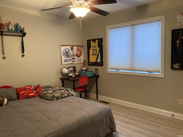 bedroom with light wood-type flooring and ceiling fan