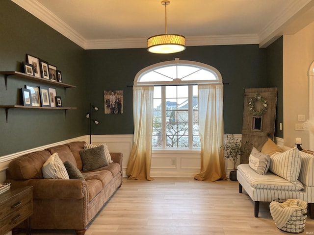 living area with crown molding and light wood-type flooring