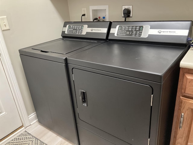 clothes washing area featuring washer and dryer