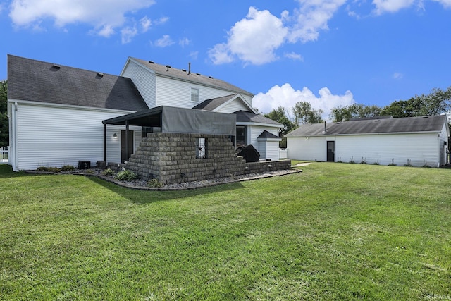 rear view of property with a yard