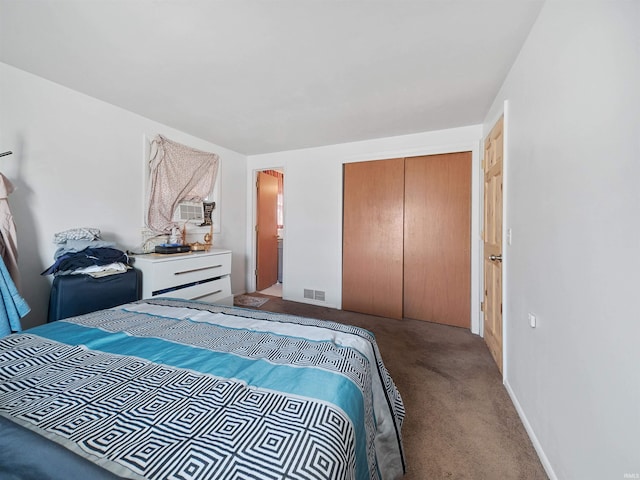 carpeted bedroom with a closet and cooling unit