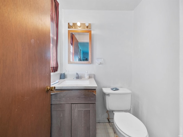 bathroom featuring toilet, tile patterned flooring, and vanity