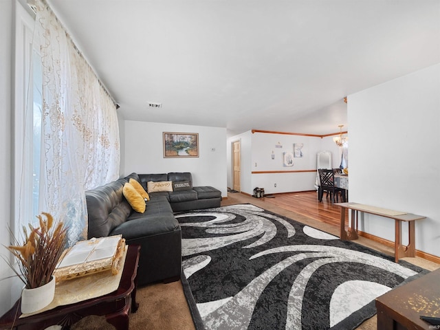 living room featuring hardwood / wood-style floors and a notable chandelier