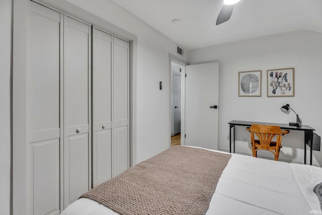 bedroom featuring ceiling fan and multiple closets