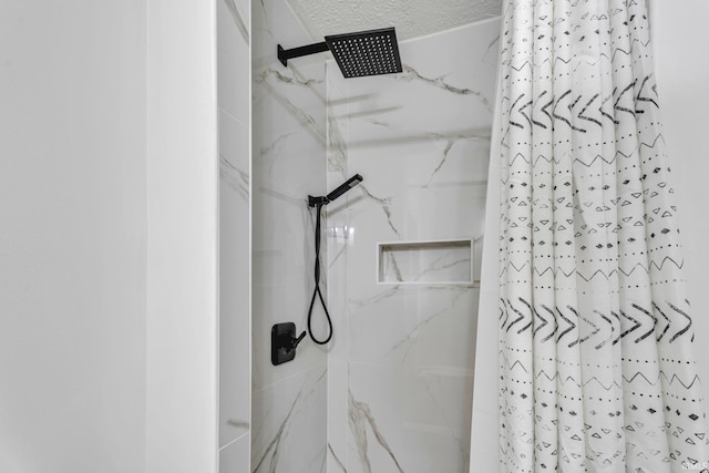 bathroom featuring curtained shower and a textured ceiling