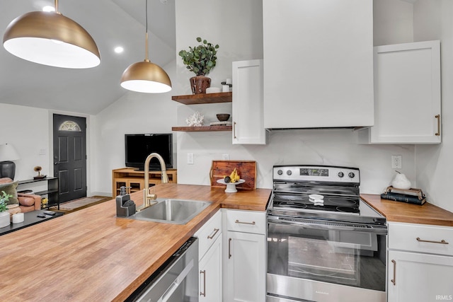 kitchen with decorative light fixtures, white cabinetry, butcher block countertops, and stainless steel appliances