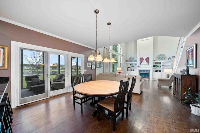 dining room with an inviting chandelier, crown molding, and dark hardwood / wood-style flooring