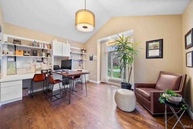 office with dark wood-type flooring, built in desk, and vaulted ceiling