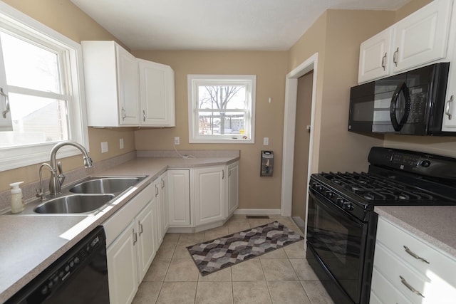 kitchen with sink, black appliances, and white cabinetry