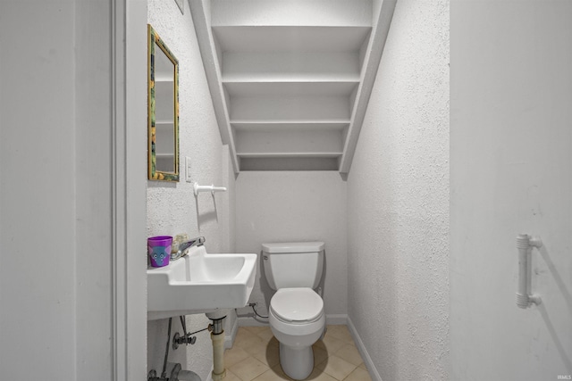 bathroom featuring sink, tile patterned floors, and toilet