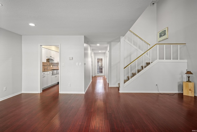 foyer featuring a textured ceiling and dark hardwood / wood-style floors