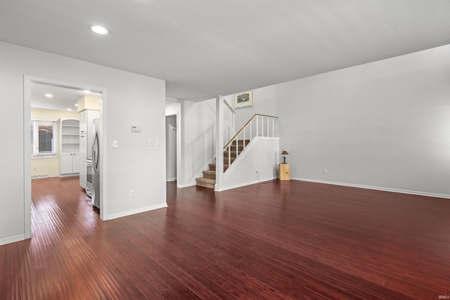 unfurnished living room with dark hardwood / wood-style flooring