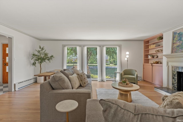 living room with light hardwood / wood-style floors, crown molding, baseboard heating, and a fireplace