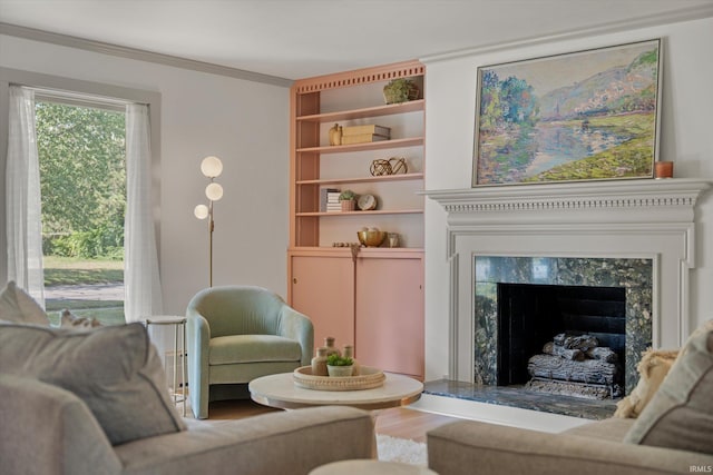 living room featuring a premium fireplace, hardwood / wood-style flooring, and crown molding