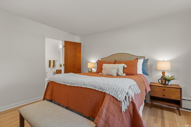 bedroom featuring hardwood / wood-style flooring and ensuite bath