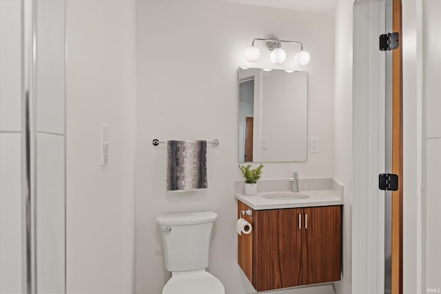 bathroom with toilet and vanity