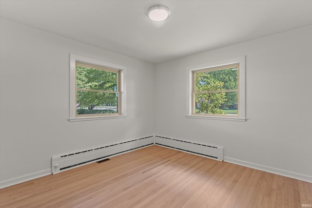 spare room with hardwood / wood-style flooring