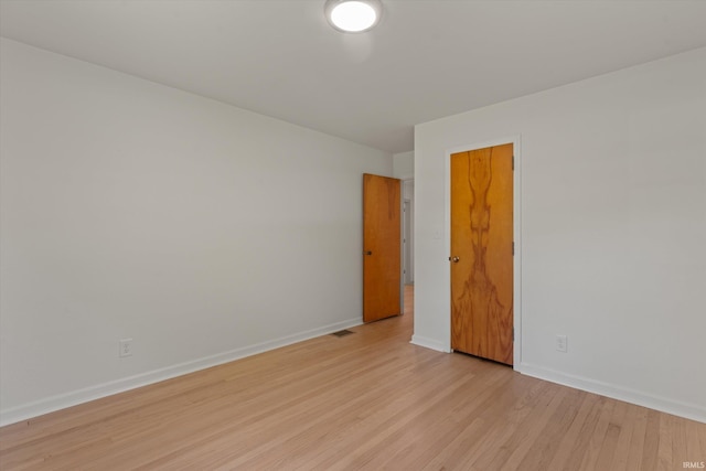 spare room with light hardwood / wood-style floors