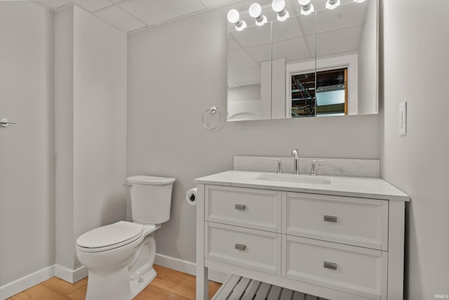 bathroom featuring hardwood / wood-style flooring, toilet, and vanity