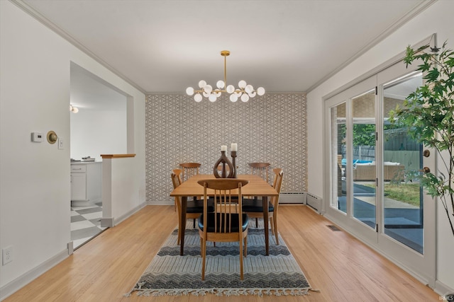 dining room featuring a chandelier, crown molding, and light hardwood / wood-style floors