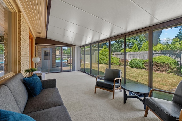 sunroom / solarium featuring lofted ceiling