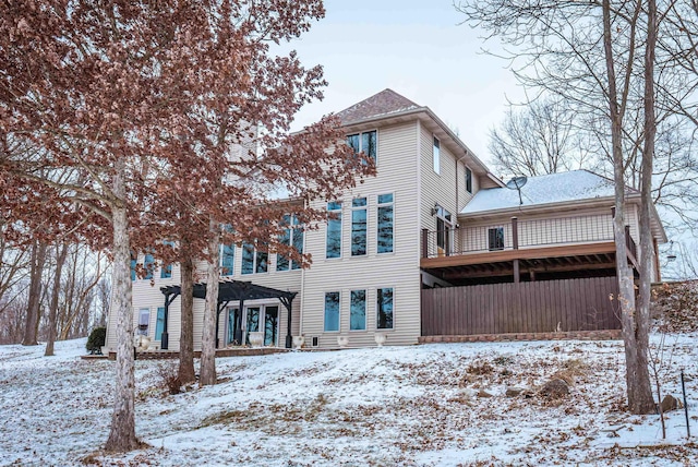 view of snow covered rear of property