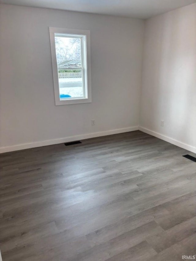 unfurnished room with hardwood / wood-style floors