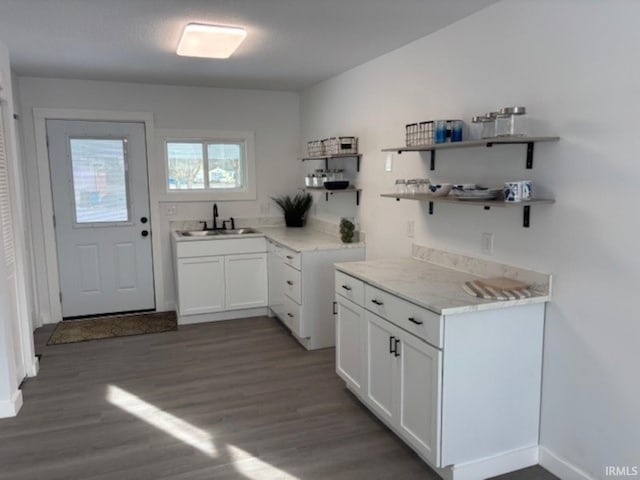 kitchen with sink, white cabinetry, and dark hardwood / wood-style floors