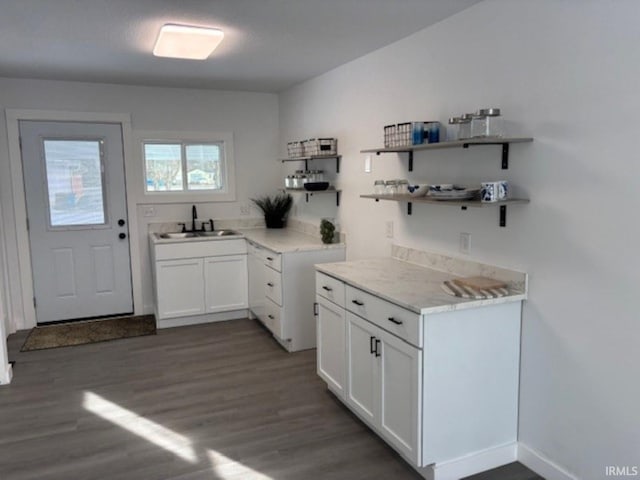 kitchen with sink, white cabinetry, and dark hardwood / wood-style flooring