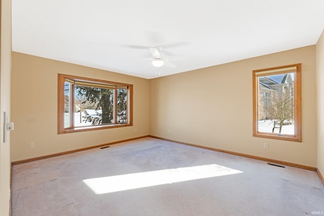 carpeted spare room with ceiling fan