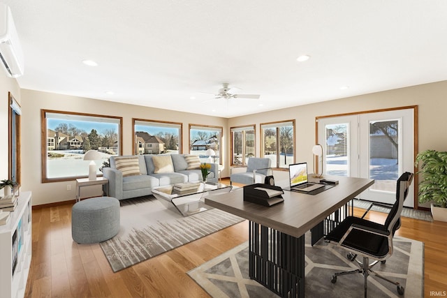 office featuring a wall mounted air conditioner and light hardwood / wood-style floors