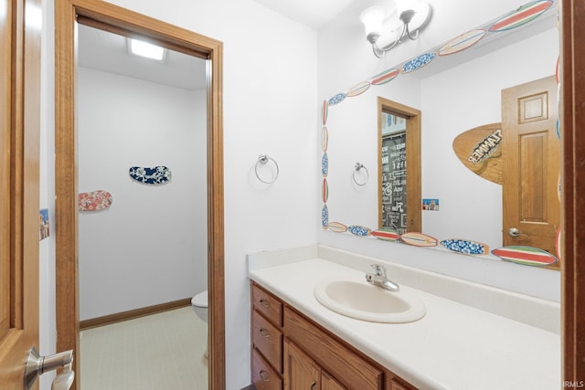 bathroom with toilet and vanity