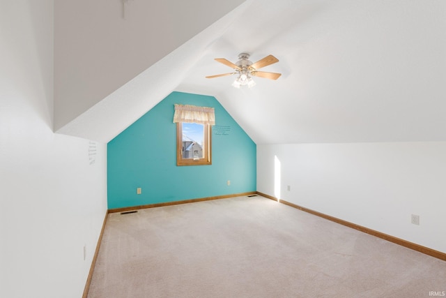 bonus room with ceiling fan, light colored carpet, and lofted ceiling