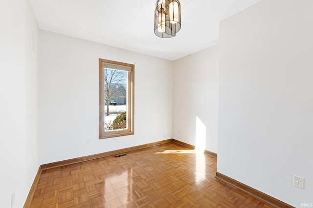 unfurnished room with parquet flooring