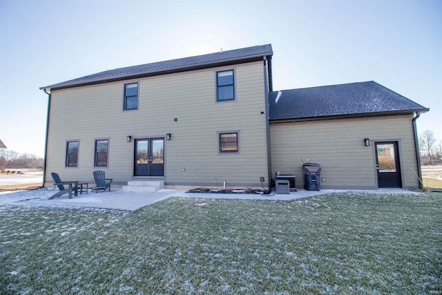 rear view of house featuring a patio, french doors, and a lawn