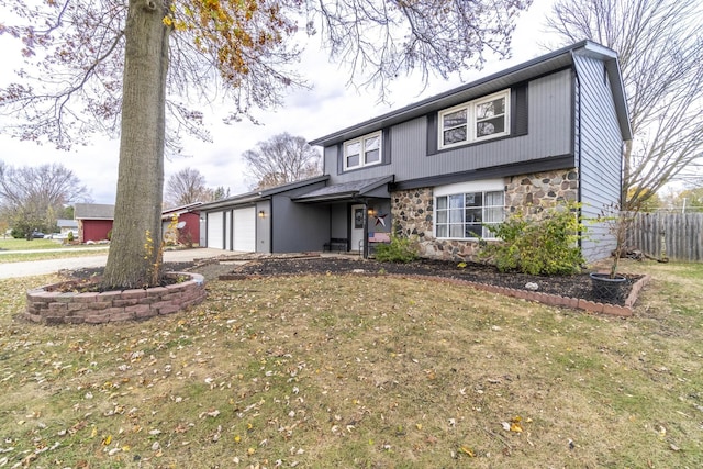 view of front of home with a garage and a front lawn