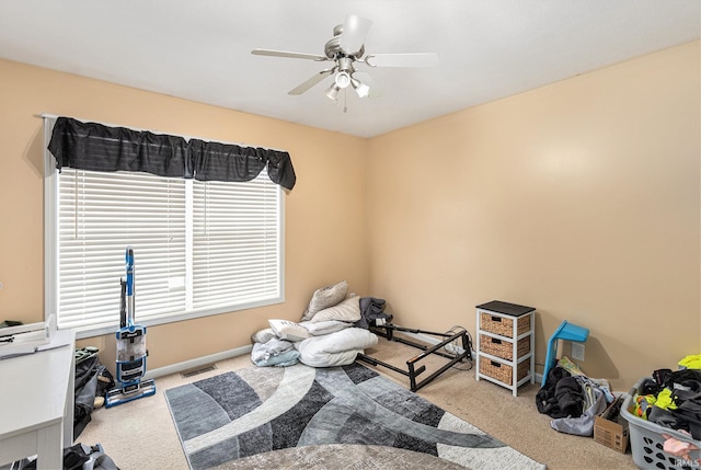 interior space with light colored carpet and ceiling fan