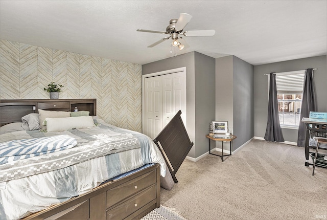 bedroom featuring ceiling fan, a closet, and light carpet