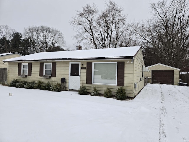 ranch-style house with a garage and an outbuilding