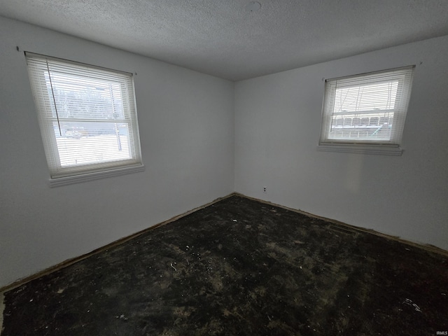 empty room featuring a textured ceiling