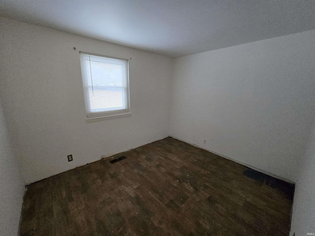 unfurnished room with dark hardwood / wood-style floors